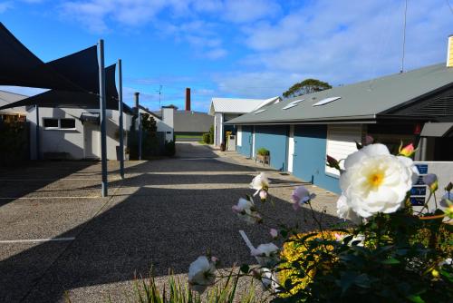 a street with buildings and flowers in the foreground at Captain's at the Bay in Apollo Bay