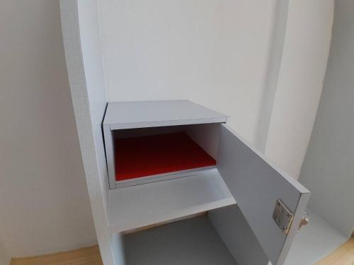 a white shelf with a red seat in a room at Toto Residence in Ao Nang Beach