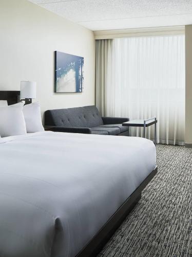 a hotel room with a large bed and a couch at Austin Marriott North in Round Rock