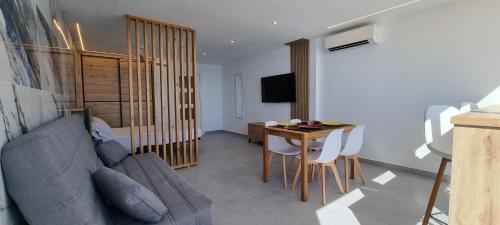 a living room with a couch and a table at Principado Benidorm Suites Levante in Benidorm