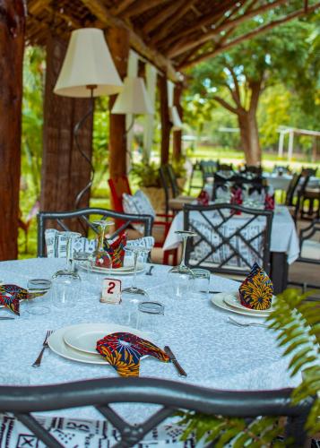 a table with a blue table cloth and plates on it at Saffron Garden Malindi in Malindi