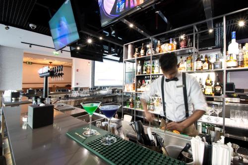 a bartender making a drink at a bar at Fairmont Bab Al Bahr in Abu Dhabi