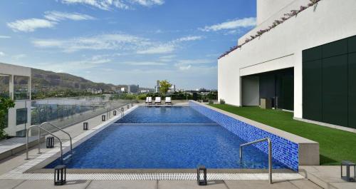 a swimming pool on the roof of a building at Marriott Executive Apartments Navi Mumbai in Navi Mumbai