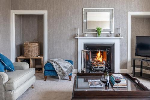a living room with a couch and a fireplace at Porte House - Holiday At Home in Richmond