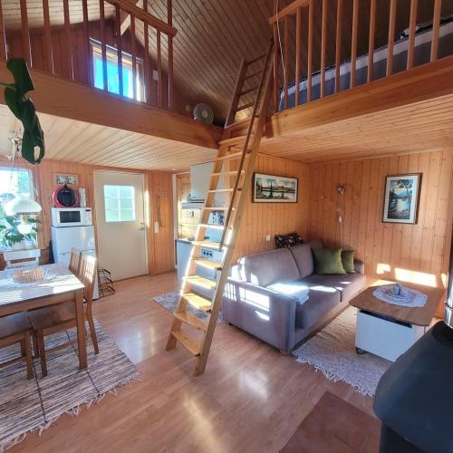 a living room with a loft bed and a couch at Stuga in Sävar