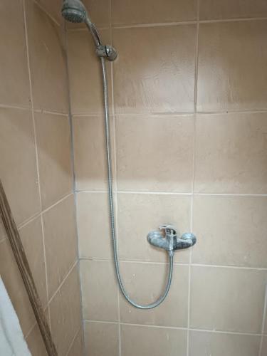a shower with a shower head in a bathroom at דירת נופש in Haifa