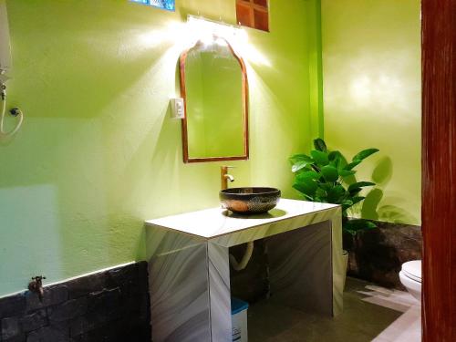 a bathroom with a sink and a mirror at Green Village Mekong in Can Tho