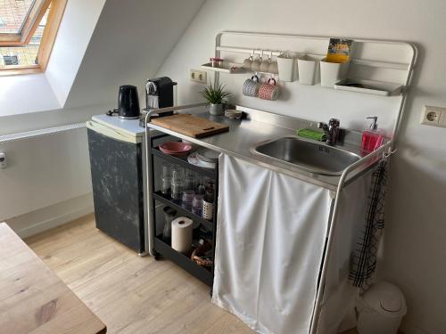 a kitchen with a sink and a counter top at Mikroapartment Leipzig in Leipzig