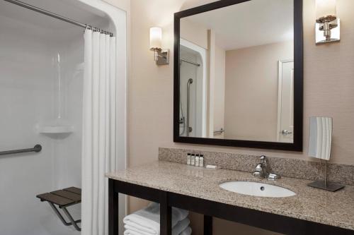 a bathroom with a sink and a mirror at Delta Hotels by Marriott Guelph Conference Centre in Guelph