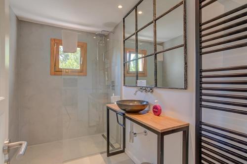a bathroom with a bowl sink and a mirror at Villa Can Gallardo by Sealand Villas in Pollença