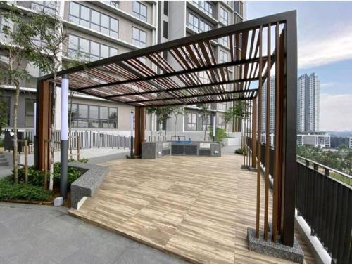 a pergola on a balcony of a building at The Clio 2 IOI Resort City, beside ioi city mall, serdang hospital, upm and uniteen in Putrajaya