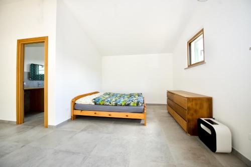 a bedroom with a bed and a dresser in it at Poggio Ferrone in Suvereto