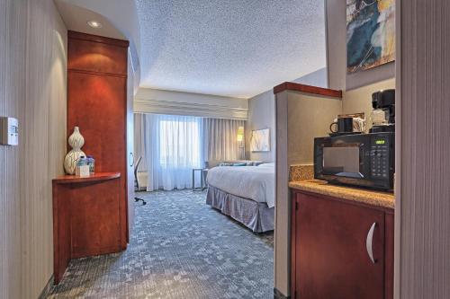 a hotel room with a bed and a microwave at Courtyard by Marriott Harrisburg West/Mechanicsburg in Mechanicsburg