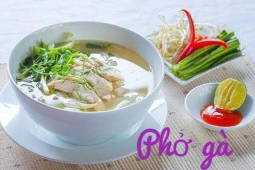 eine Schüssel Suppe auf einem Teller auf einem Tisch in der Unterkunft Mộc House in Mộc Châu