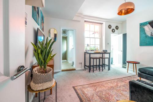 a living room with a table and a potted plant at The Artist's Retreat in Brighton & Hove