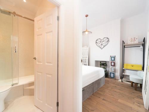 a bedroom with a bed and a bathroom at Pass the Keys Cosy and Chic Flat Near Greenwich Park in London
