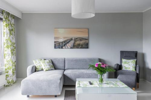 a living room with a couch and a table at Arctic Holiday Apartments 3 in Rovaniemi