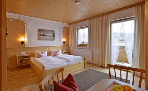 1 dormitorio con 1 cama y 1 mesa en una habitación en Hüttschmiedhof en Kössen