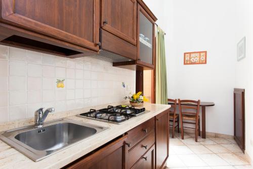 a kitchen with a sink and a stove at Residence Marina Corta in Lipari