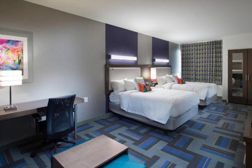 a hotel room with two beds and a desk at SpringHill Suites by Marriott Houston Hwy. 290/NW Cypress in Houston