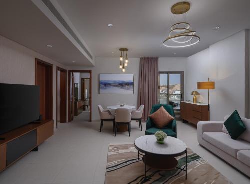 a living room with a couch and a table at DoubleTree by Hilton Muscat Qurum in Muscat