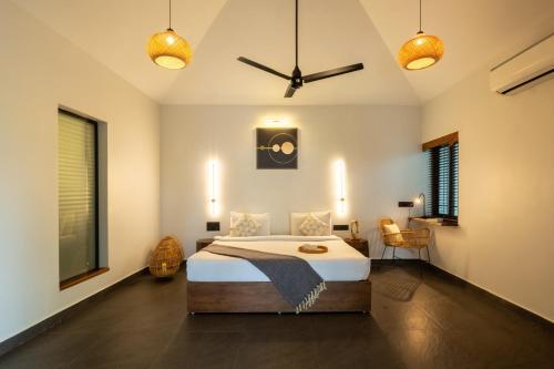 a bedroom with a bed and a ceiling fan at C Roque Beach Resort in Colva