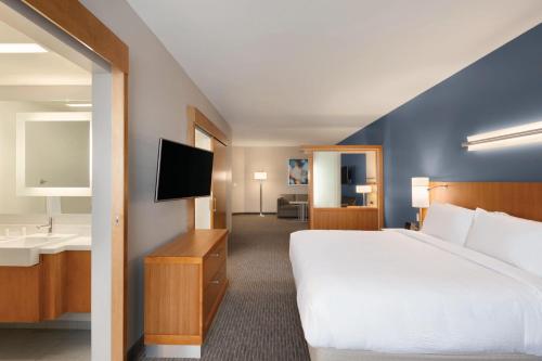 a hotel room with a bed and a sink at SpringHill Suites by Marriott Houston Northwest in Houston