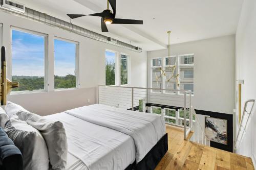 a white bedroom with a bed and a window at Iridescence Center Midtown Piedmont Park King Bed Loft in Atlanta
