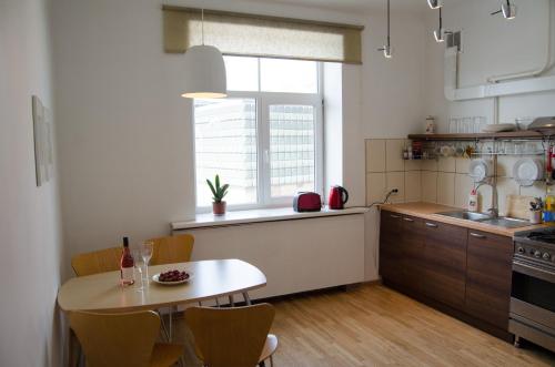 a kitchen with a table and a dining room at City Inn Riga Apartment, Town Hall view with parking in Rīga