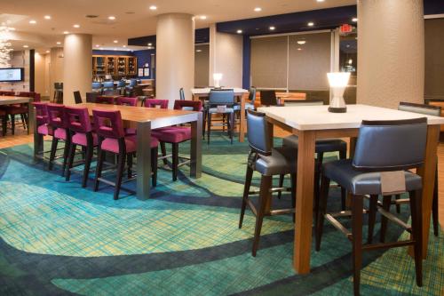 a dining room with tables and chairs in a restaurant at SpringHill Suites by Marriott Houston Westchase in Houston
