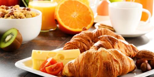 een bord croissants en andere voedingsmiddelen op een tafel bij Sun N Sand Beach Resort in Mombasa