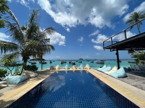 a swimming pool with a view of the ocean at Lipe Power Beach Resort in Ko Lipe