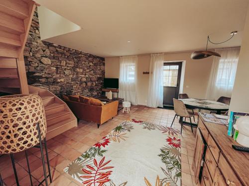 a living room with a couch and a table at Domaine du Mimosa in Perros-Guirec