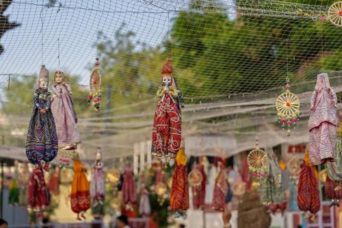 a bunch of dolls are hanging from a net at Gaj Kesri by 7Apple Resorts in Bikaner