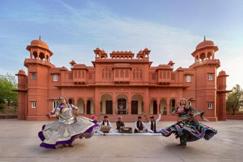 a group of people dancing in front of a building at Gaj Kesri by 7Apple Resorts in Bikaner