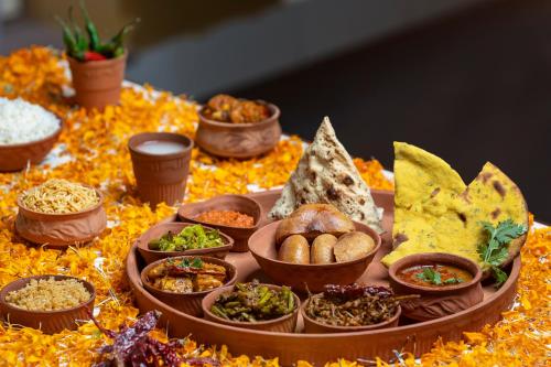 a tray of different types of food on a table at Gaj Kesri by 7Apple Resorts in Bikaner