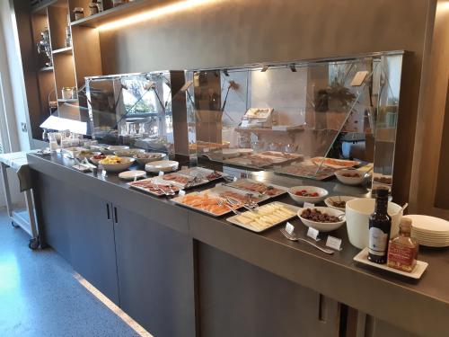 a buffet line with many different types of food at Grand Universe Lucca, Autograph Collection in Lucca