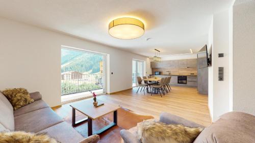 a living room with a couch and a table at PitzPlus Appartements in Sankt Leonhard im Pitztal