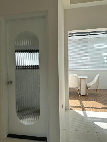 a door to a room with a table and chairs at Muzhu B&B in Yilan City