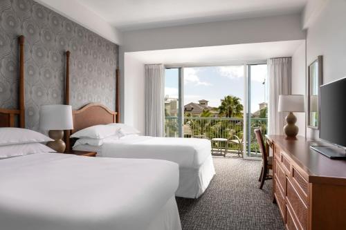 a hotel room with two beds and a balcony at Sheraton Princess Kaiulani in Honolulu