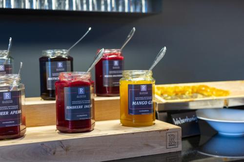 a group of jars of honey on a wooden shelf at Wellness & Naturresort Reischlhof in Wegscheid