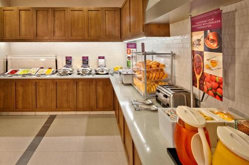 a kitchen with a counter with food on it at Residence Inn by Marriott Orlando Downtown in Orlando