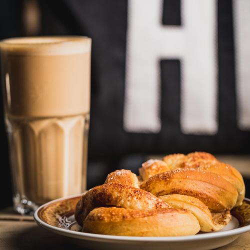 a plate of pastries on a table with a glass of milk at Highland Lodge Fjellandsby in Geilo