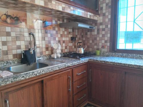 a kitchen with a sink and a counter top at Villa in Oulad Akkou