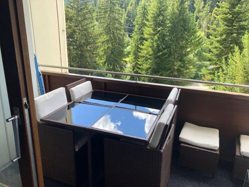 a room with a window with a view of trees at Laax with indoor and outside pool, sauna, 200 Meter to Ski lift , Fitnessroom, Tennis Place, Joyroom, Parkstadion Reserve in Laax