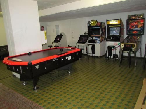 a room with several arcade games and a pool table at Laax with indoor and outside pool, sauna, 200 Meter to Ski lift , Fitnessroom, Tennis Place, Joyroom, Parkstadion Reserve in Laax