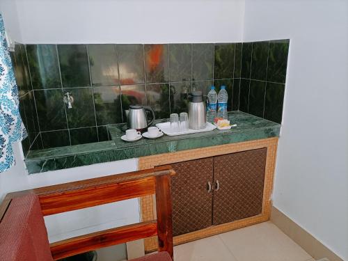 a bathroom with a green counter with a sink at Laxmi Narayan Residency in Puri