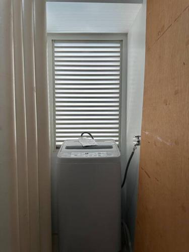 a window in a room with a trash can at New Avida Cebu 2BR(50mbps,6pax) in Cebu City