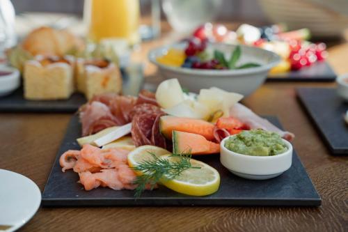 a black plate of food on a wooden table at Hotel Schachner in Maria Taferl