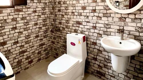 a bathroom with a toilet and a sink at Wadi Shab Beach Villa in Sur